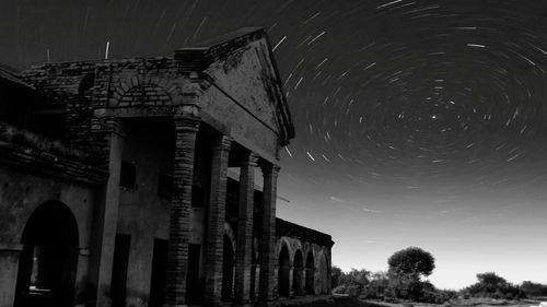 Low angle view of building against clear sky at night
