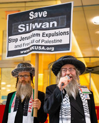 Portrait of man with text on the sign