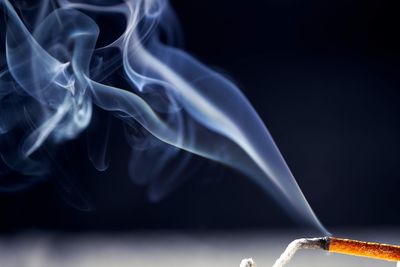 Close-up of cigarette against black background