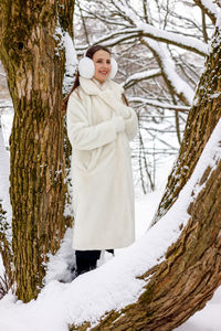 Rear view of woman standing on snow