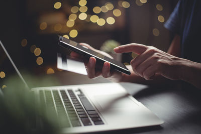 Midsection of man using mobile phone