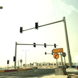 Road sign against sky