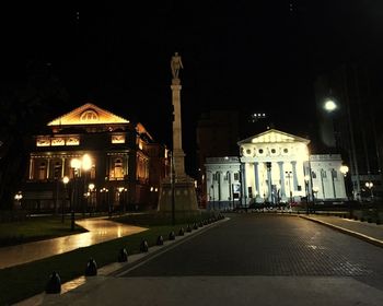 Illuminated city against sky at night