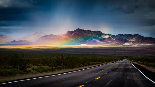 Road by landscape against sky