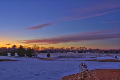 Scenic view of landscape against sky during winter