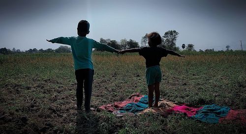 Rear view of women standing on field