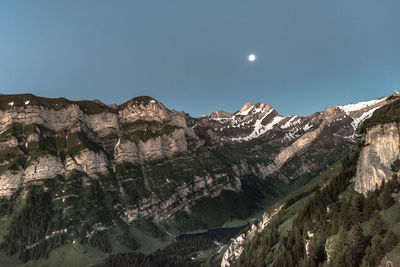 Scenic view of mountains against clear sky at night