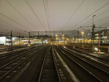 Railroad tracks in city against sky