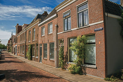 Popular brick houses in a narrow empty street at weesp. a pleasant small village in netherlands.