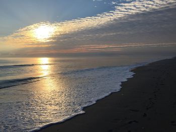 Scenic view of beach against sky during sunset