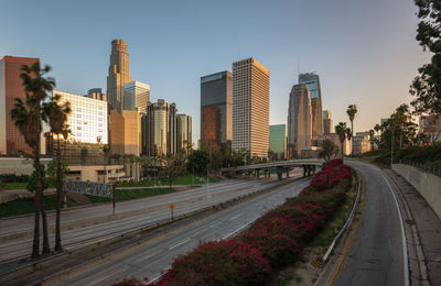 View of city street and buildings against sky