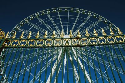 Low angle view of illuminated ferris wheel against sky