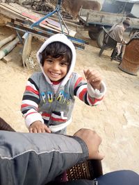 Portrait of smiling boy sitting outdoors