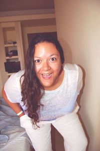 Portrait of smiling young woman sitting at home