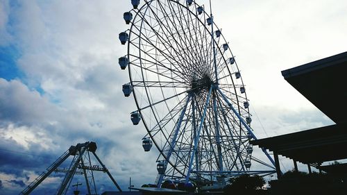 Low angle view of ferris wheel against sky