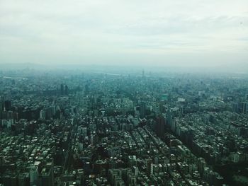 Aerial view of cityscape against sky