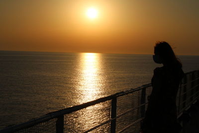 Scenic view of girl ona  boat against sky during sunrise