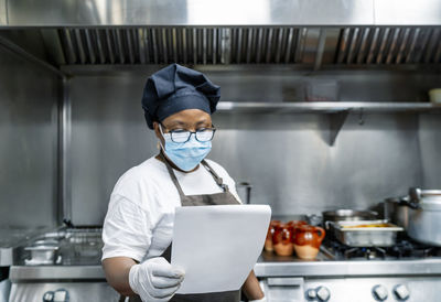 Cook looking at the menu to prepare the menu