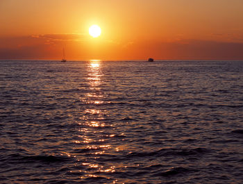 Scenic view of sea against romantic sky at sunset