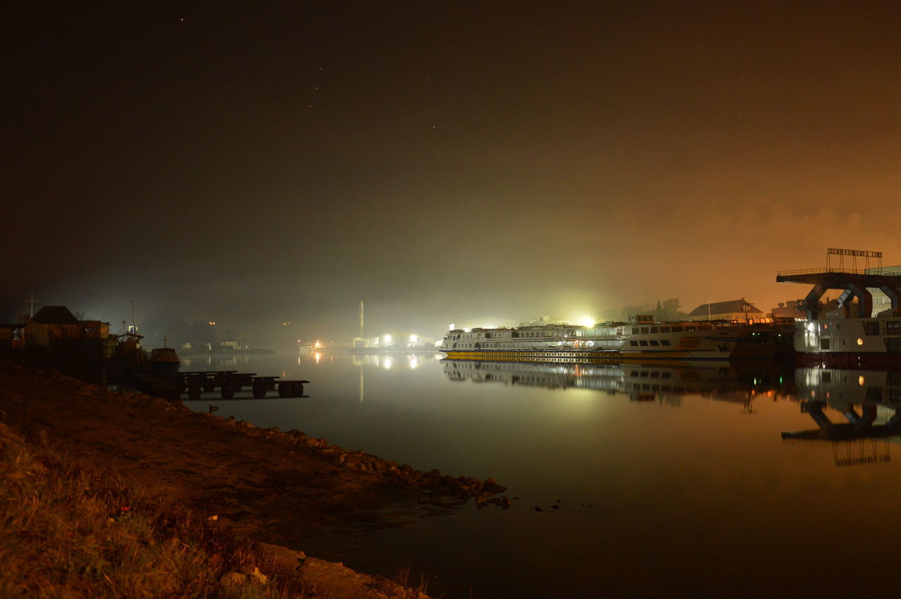 water, building exterior, sea, built structure, architecture, illuminated, sky, reflection, night, waterfront, copy space, dusk, tranquility, scenics, nature, tranquil scene, outdoors, city, nautical vessel, beauty in nature