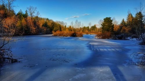 Scenic view of landscape against sky during winter