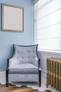 Large armchair by the window and picture frame