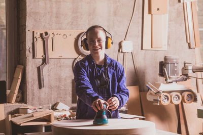 Portrait of teenage girl wearing sunglasses standing on table