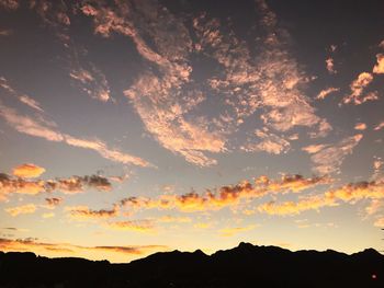 Low angle view of silhouette mountain against dramatic sky