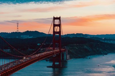 Golden gate bridge over river during sunset