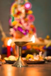 Close-up of illuminated candles on table