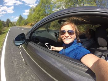 Portrait of boy wearing sunglasses in car