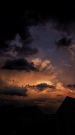 Silhouette buildings against sky at sunset