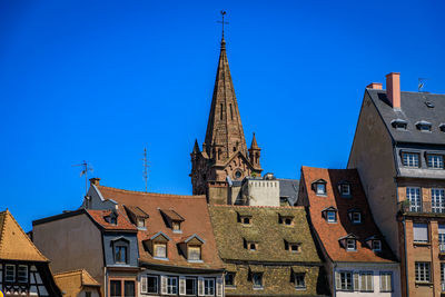 Low angle view of building against clear blue sky