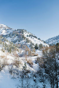 Beautiful rock mountains covered with snow in winter in sunny weather 