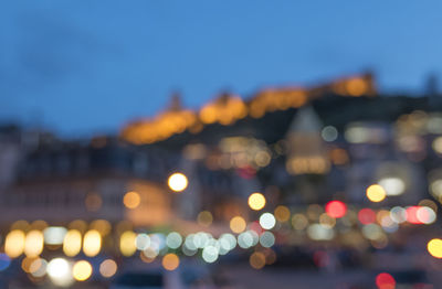 Defocused image of illuminated city at night