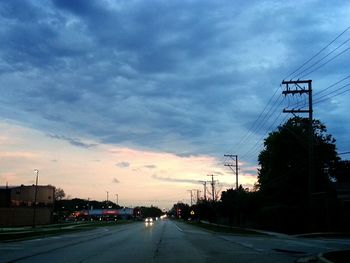 Road against cloudy sky at sunset