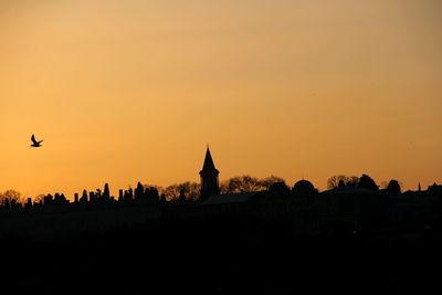 Silhouette of built structure at sunset