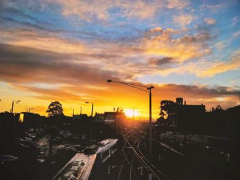Silhouette city against sky during sunset
