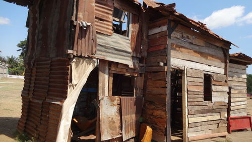 Low angle view of abandoned building against sky