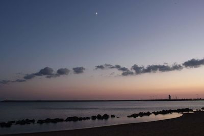 Silhouette of people on beach at sunset