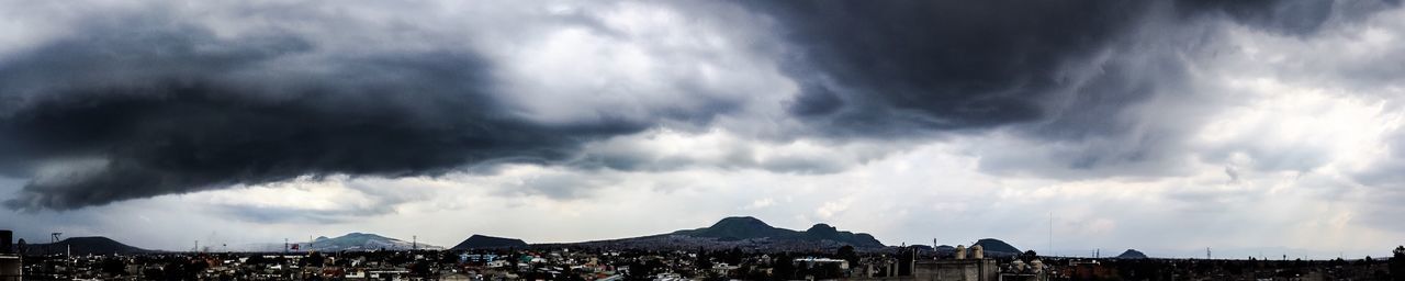 View of town against cloudy sky