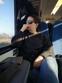 Man sitting on chair in bus