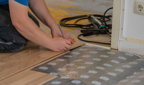 Low section of man working at table