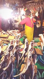 Rear view of people at market stall