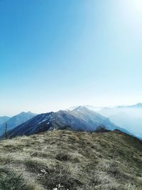 Scenic view of mountains against clear blue sky