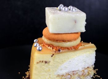 Close-up of cake against black background
