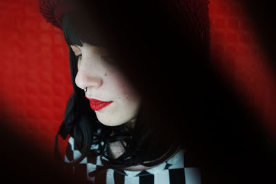 Close-up of young woman against wall