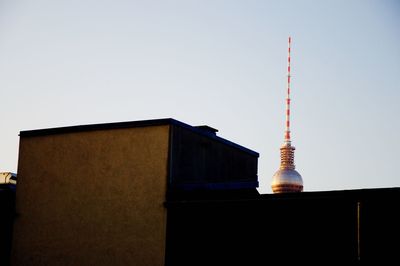 Low angle view of communications tower against sky