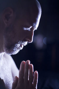 Young bearded man shirtless relaxing at home, home shelter, meditation and yoga, pray