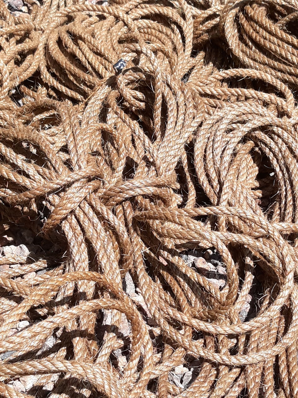 FULL FRAME SHOT OF ROPE ON TEXTURED SURFACE